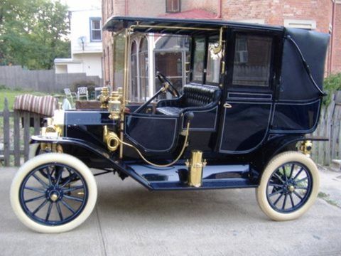 1909 Ford Model T - This antique automobile features a high-mounted steering wheel and a covered passenger compartment.