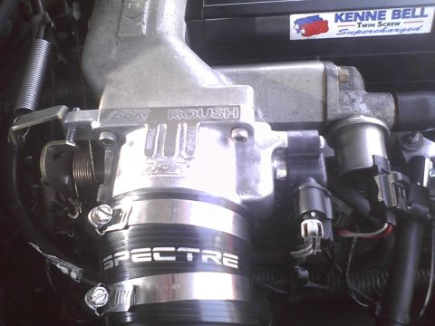 2003 Ford Crown Victoria - Close-up of engine components, including a Roush intake and a Kenne Bell supercharger sticker.