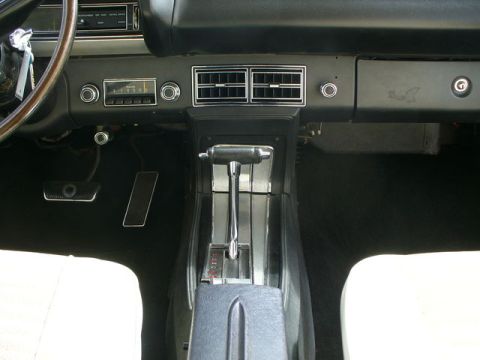 1970 Ford Torino - The interior of a 1970 Ford Torino features a floor-mounted shifter and a dark dashboard.