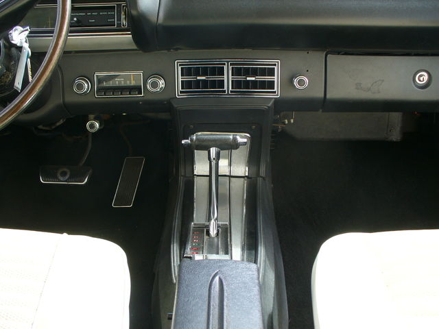 1970 Ford Torino interior showing dashboard, steering wheel, floor shifter, and pedals