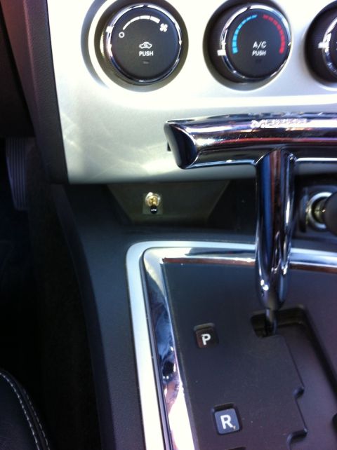 2010 Dodge Challenger - Interior view of a car's center console, highlighting climate controls and a custom toggle switch.