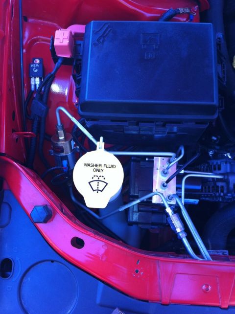 2010 Dodge Challenger - Engine bay view showing washer fluid reservoir cap and various electrical components.