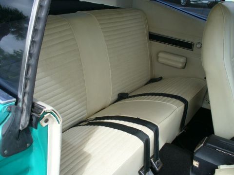 1970 Ford Torino - Interior view of a 1970 Ford Torino, highlighting the beige seats and teal door trim.