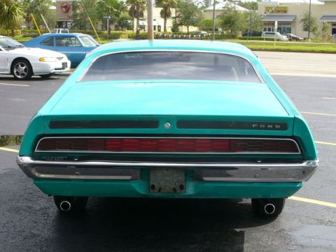 1970 Ford Torino - Rear view of a teal 1970 Ford Torino with a chrome bumper and distinctive horizontal taillights.