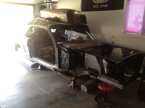 1965 Ford Mustang - This car is undergoing restoration, with its body stripped down and parts removed.