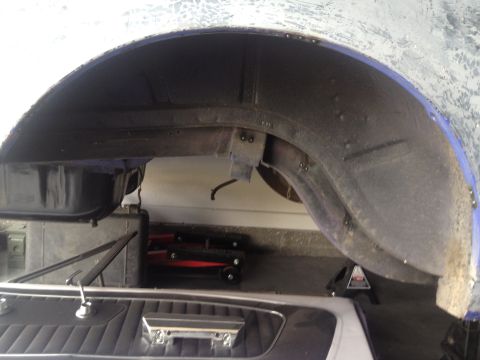 1965 Ford Mustang - A view of the rear wheel well and interior of a 1965 Ford Mustang during restoration.
