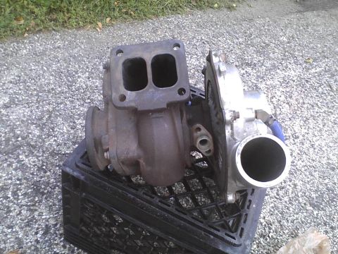 2003 Ford Crown Victoria - Pair of turbochargers shown on a crate outdoors.