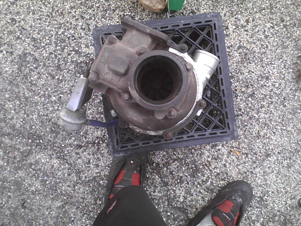 Turbocharger on a black grate, with feet in the foreground