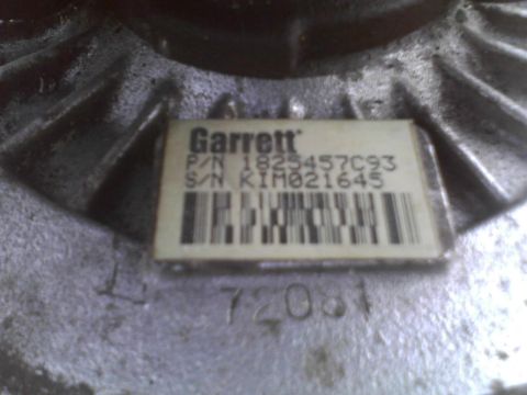 2003 Ford Crown Victoria - Close-up of a Garrett turbocharger part, showing the part number and serial number.