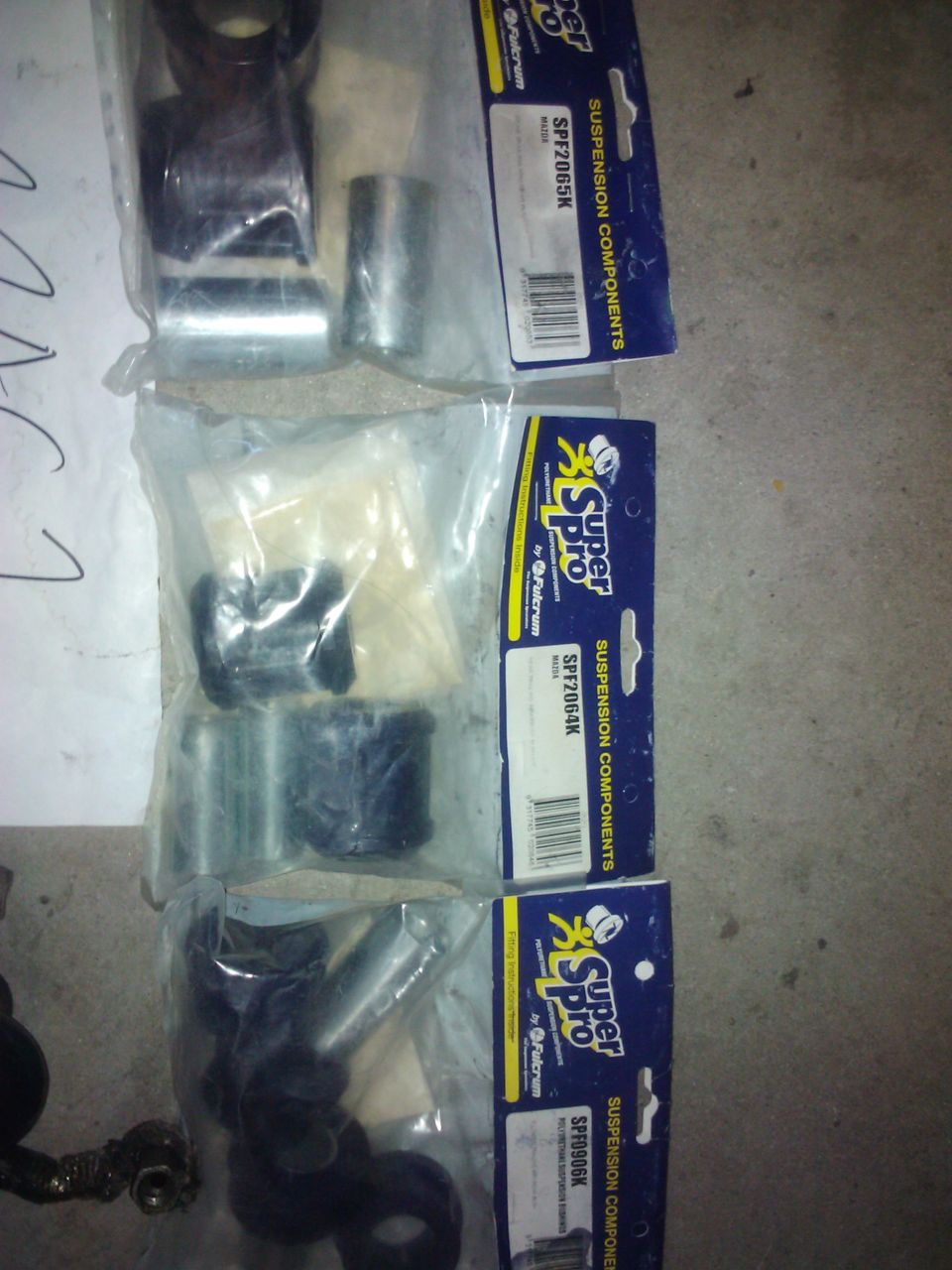 Super Pro suspension components in packaging, part numbers SPF2065K and SPF2064K visible