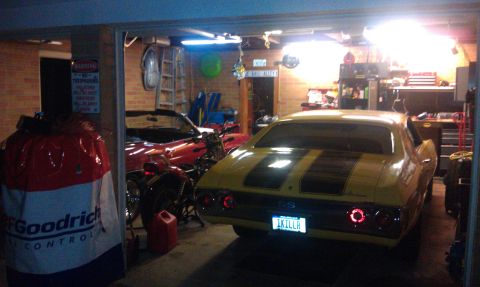 1979 Ford Bronco - A yellow 1970 Chevrolet Chevelle SS is parked in a garage next to a red convertible and a motorcycle.