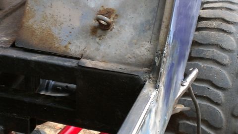 1978 Ford Bronco - This image shows a close-up view of a vehicle's frame, tire, and some welding details.