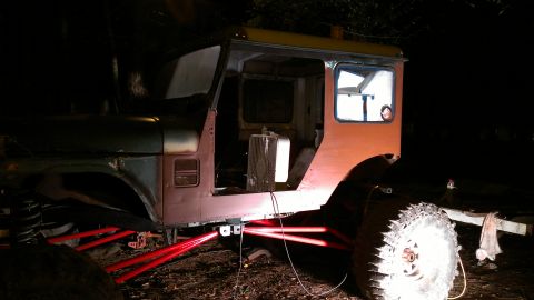 1978 Ford Bronco - Vehicle body undergoing restoration, with custom red suspension parts installed.