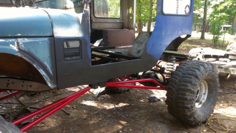 1978 Ford Bronco - This modified off-road vehicle chassis shows extensive suspension work and a partial body, with visible Supermotors.net branding.