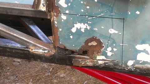 1978 Ford Bronco - Detail of heavily rusted vehicle frame and body panel, showing structural damage.