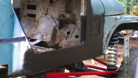 1978 Ford Bronco - This photo shows a heavily rusted vehicle frame and fender, with suspension parts visible.