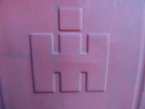 1961 International Scout 80 - Close-up of the International Harvester logo, likely on a vehicle part.