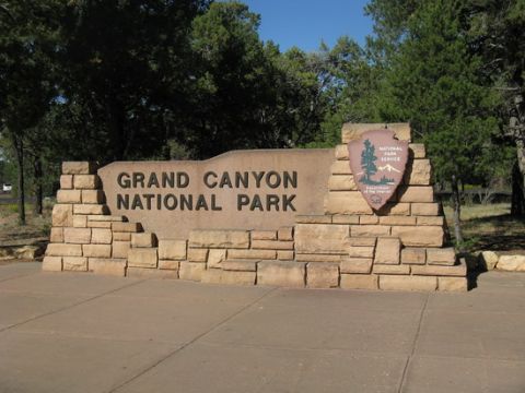 1991 Ford LTD Crown Victoria - The large stone sign reads "GRAND CANYON NATIONAL PARK" and features the National Park Service logo.