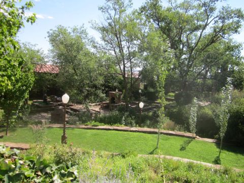 1991 Ford LTD Crown Victoria - Outdoor garden area with landscaping and architectural elements under a clear sky.