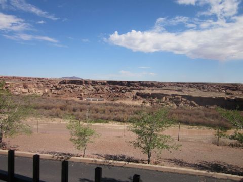 1991 Ford LTD Crown Victoria - A wide view of the Grand Canyon under a bright blue sky with scattered clouds.