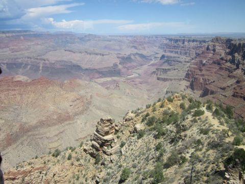 1991 Ford LTD Crown Victoria - A vast expanse of the Grand Canyon under a partly cloudy sky, its immense geological features.