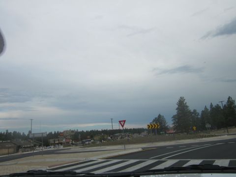 1991 Ford LTD Crown Victoria - View of a road intersection with traffic signs and buildings in the distance.