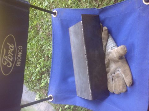1995 Ford Bronco - A blue tarp displays a Ford Bronco logo next to a metal object and a work glove.