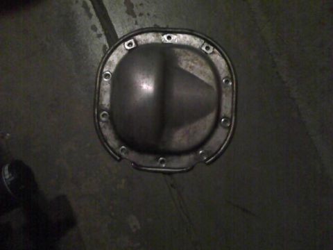 2003 Ford Crown Victoria - Differential cover shown on a dark, possibly concrete surface.