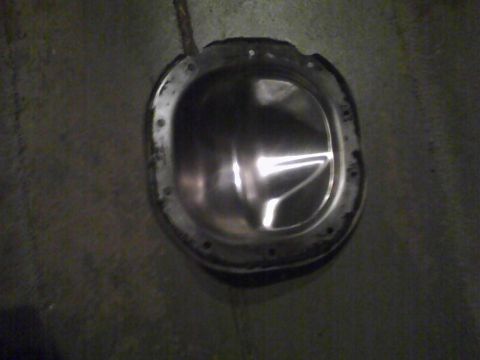 2003 Ford Crown Victoria - Differential cover shown on a concrete floor, likely removed from a vehicle for maintenance or upgrade.
