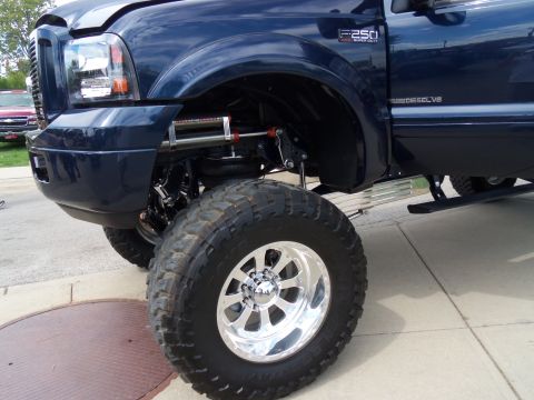1989 Ford Bronco - This lifted Ford F-250 Super Duty features a prominent F250 badge and a custom suspension system.