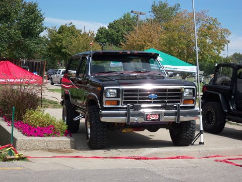 1989 Ford Bronco - This 1989 Ford Bronco is parked at an outdoor event with a Jeep nearby.