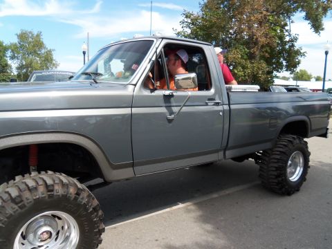 1989 Ford Bronco - This lifted pickup truck features aggressive off-road tires and a prominent side profile.