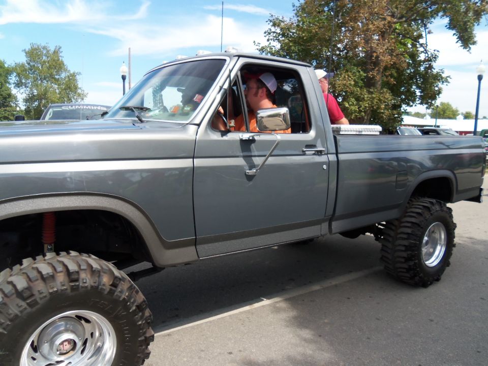 Gray pickup truck, side view, lifted suspension, large tires