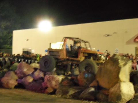 1989 Ford Bronco - A custom off-road buggy navigates a rock obstacle course at night.