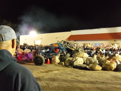 1989 Ford Bronco - Off-road buggies navigate a rock obstacle course at night, drawing a crowd.