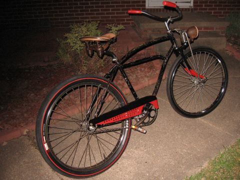 1994 Ford Bronco - A custom cruiser bicycle with red-striped tires and a vintage headlight sits on a concrete path.