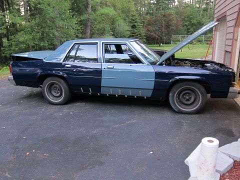 1991 Ford LTD Crown Victoria - This 1991 Ford Crown Victoria has a two-tone paint scheme and the hood is open.