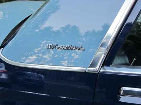 1991 Ford LTD Crown Victoria - The LTD Crown Victoria badge is visible on the rear pillar of this two-tone sedan.