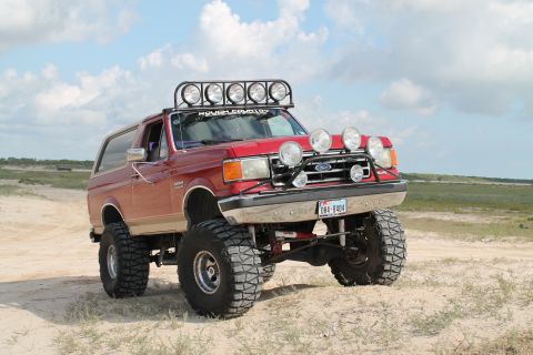 1990 Ford Bronco - This lifted 1990 Ford Bronco features numerous off-road lights and a custom light bar, ready for adventure.