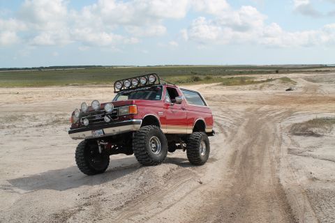 1990 Ford Bronco - This modified Ford Bronco is equipped for off-road adventures with its lifted suspension and multiple light bars.