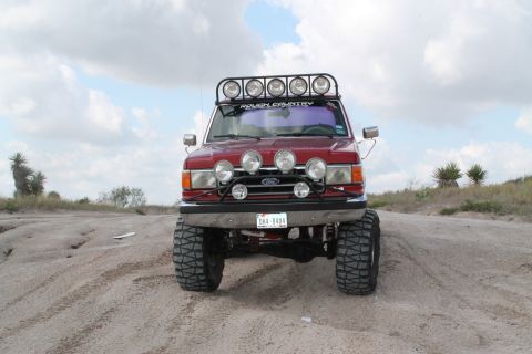 1990 Ford Bronco - This lifted Ford Bronco is equipped for off-road adventures with multiple auxiliary lights and a roof-mounted light bar.