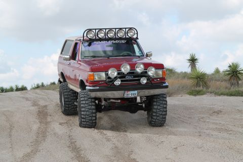 1990 Ford Bronco - This lifted Ford Bronco is ready for off-road adventure with its aggressive tires and multiple light bars.