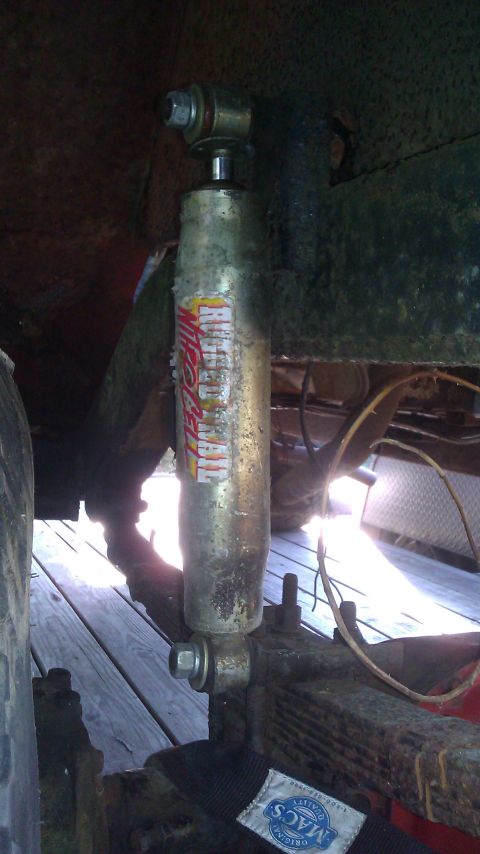 1961 International Scout 80 - A Gabriel shock absorber is mounted to the leaf spring assembly of a vehicle.
