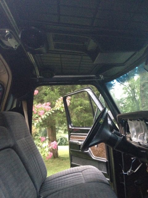 1979 Ford Bronco - The interior of a 1979 Ford Bronco is visible, with the driver's seat and dashboard in view.