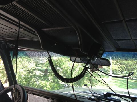 1979 Ford Bronco - The interior of the vehicle shows a CB radio mounted near the rearview mirror, with visible wiring and a coiled cord.