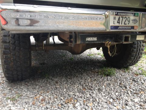 1979 Ford Bronco - The rear of a vehicle is shown, including its bumper, hitch, and license plate.