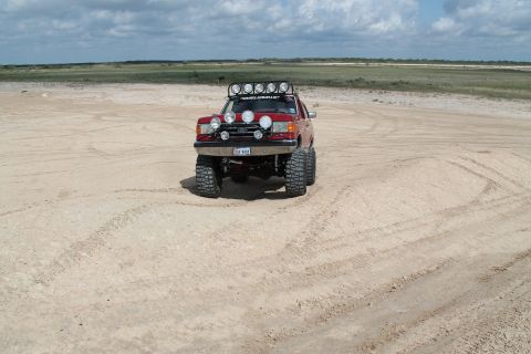 1990 Ford Bronco - This modified SUV is equipped with numerous lights and large tires, ready for off-road adventures.