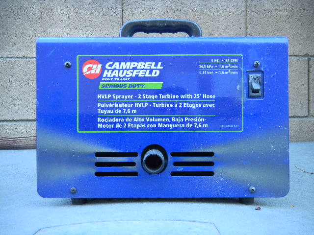 Blue Campbell Hausfeld HVLP sprayer with a label detailing its specifications and a power switch