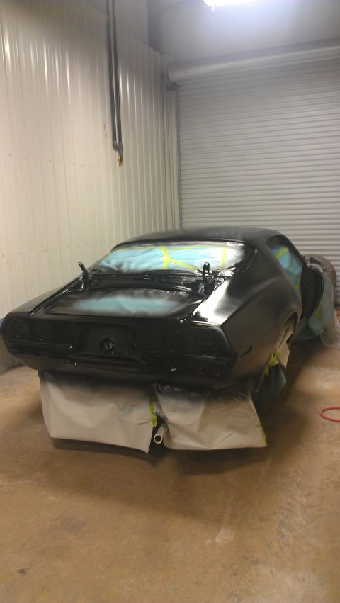 1973 Chevrolet Camaro - Car body being prepped for paint in a spray booth, rear view.