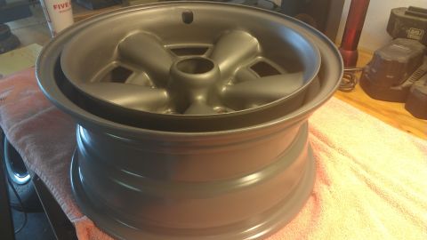 1973 Chevrolet Camaro - A single car wheel is shown in detail, sitting on a soft cloth with tools in the background.